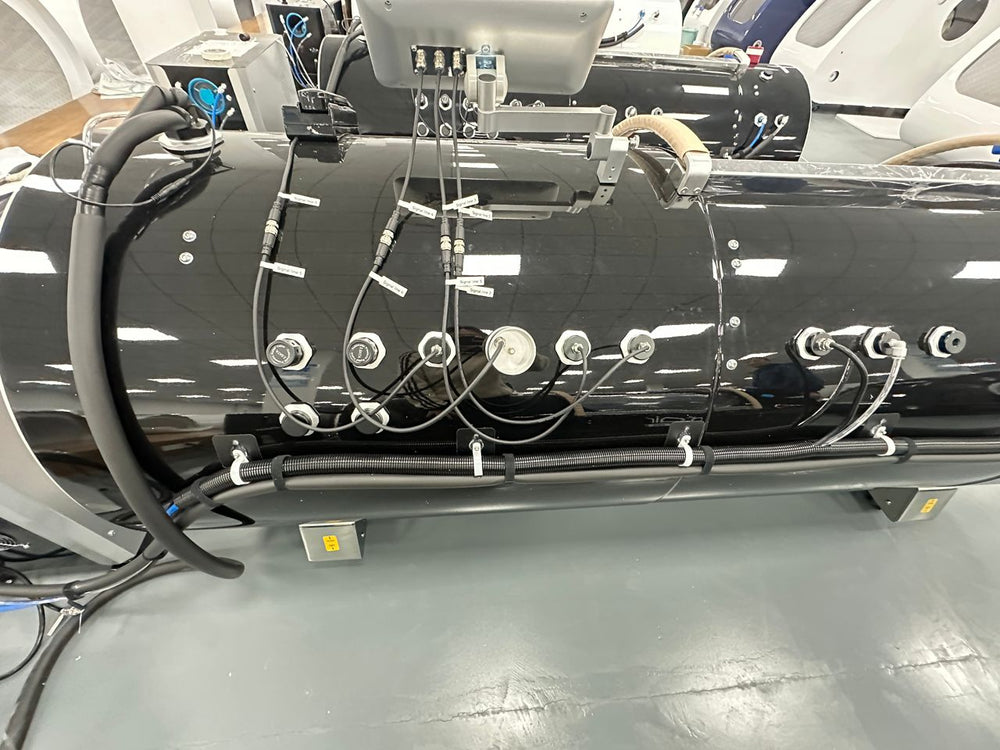 MedEq TimeCapsule Vision C900+ hard-shell hyperbaric chamber: hose and valve fittings on the shell