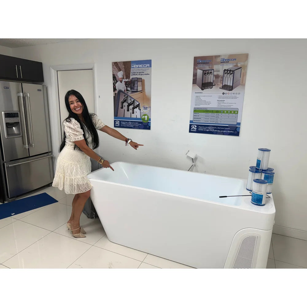 Woman pointing at the empty basin of the AMBOHR All-in Ice Bath Systems tub inside a retail showroom