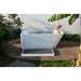 Woman soaking in the AMBOHR All-in Cold Plunge Spa on a garden deck with the slatted step mat alongside