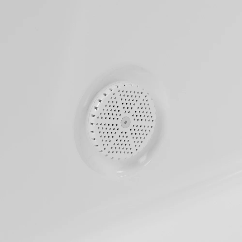 Close-up of the perforated circular drain cover in the acrylic floor of the AMBOHR Cold Plunge Fiber Core Flex Tub FiberCore Flex