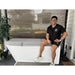 Man sitting on a covered patio plunge tub chilled by the AMBOHR Ultra Chiller Water Chiller unit at home