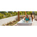 Woman reacting to cold water in an outdoor tub with an alpaca nearby, AMBOHR Ultra Chiller Cold Plunge lifestyle scene