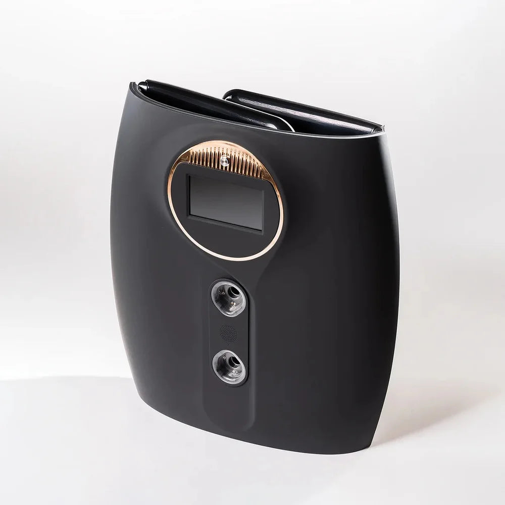 Angled view of the folded matte black shell, rose-gold screen ring and mist ports on the Galaxy Zero Atlas Touchscreen LED Therapy device