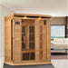 Hemlock cabin of the Maxxus MX-K306-01-ZF Sauna staged in a living room beside a white sofa with roof lights glowing