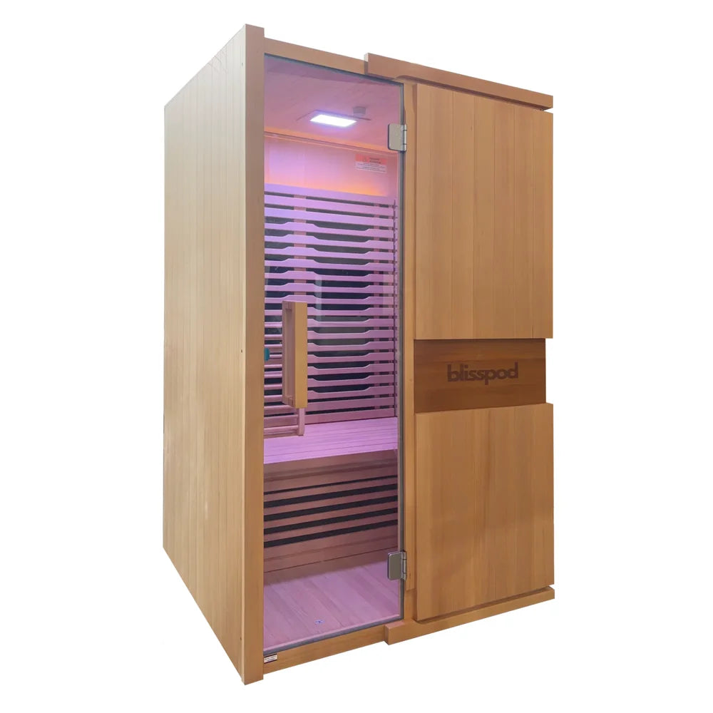 Angled view showing front and side of the Blisspod Milano Sauna with pink lit two person interior