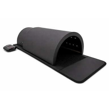 Angled view of the black leather KoreLight KorePOD Wellness Pod with two dome sections, long mat and wired controller