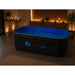 Black rectangular Dreampod Home Float FLEX Float Tank filled with water in a candlelit spa room, shown from a front angle