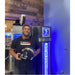 Football player with helmet standing next to blue-lit Cryo Innovations XR Cryotherapy Chambers on site