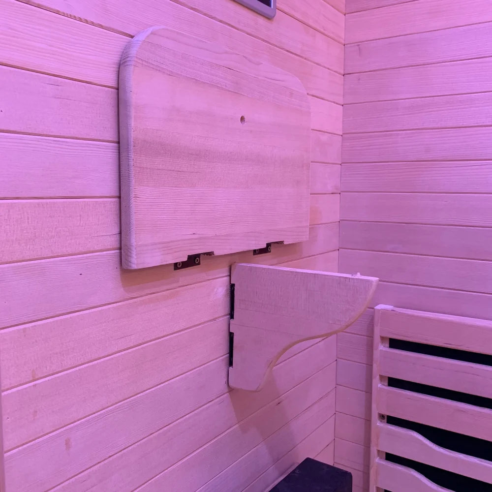 Wooden backrest board above a folding tray bracket inside the Blisspod Helsinki Infrared Sauna cabin