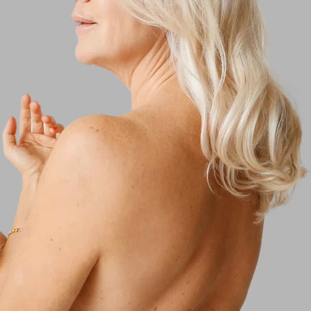 Mature model with clear even skin across her shoulder, a result associated with the Galaxy Zero Atlas LED Therapy Device