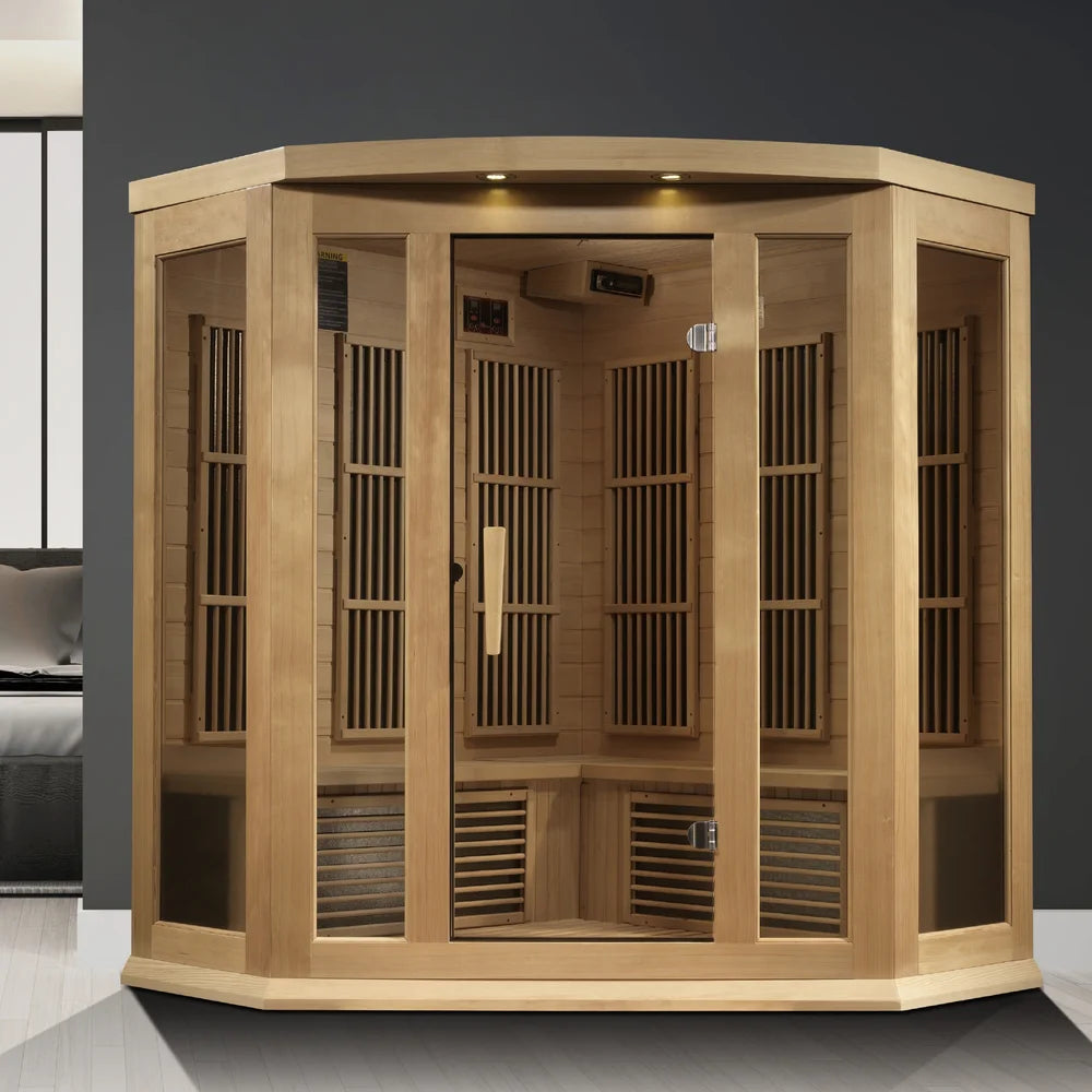 Hemlock corner cabin staged beside a bed in a grey bedroom, the Maxxus MX-K356-01-ZF Far Infrared Sauna with glass door