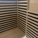 Interior corner with bench, hemlock floor and slatted heater walls in the Blisspod Bergen Sauna Pod