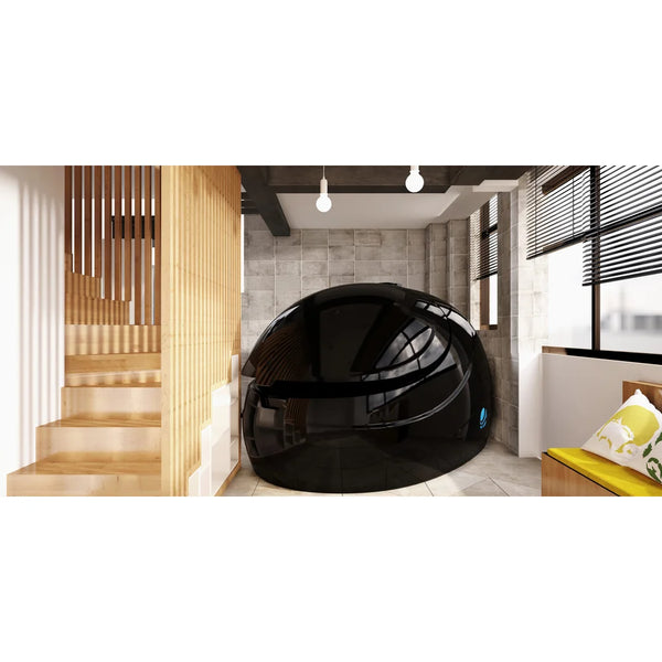 Glossy black Dreampod Sport Float Pod positioned in a home hallway beside a timber staircase and bench seat
