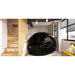 Glossy black Dreampod Sport Float Pod positioned in a home hallway beside a timber staircase and bench seat