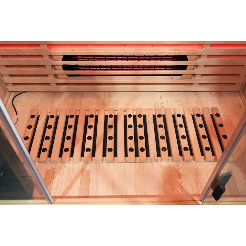 Oxygen ion stones embedded in the wooden footrest above the floor heater in the Blisspod Venetian RED Infrared Sauna