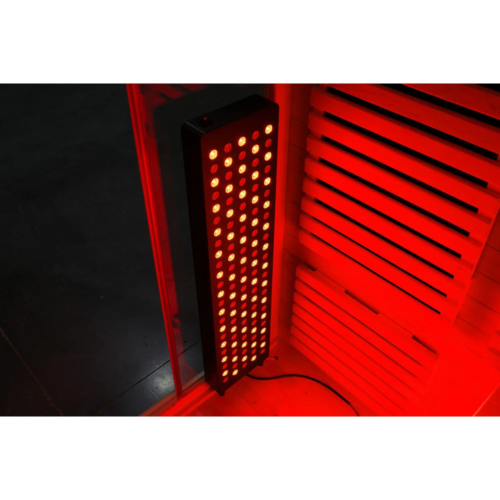 Large LED therapy panel glowing deep red against the wood slat wall of the Blisspod Venetian RED Red Light Therapy Sauna