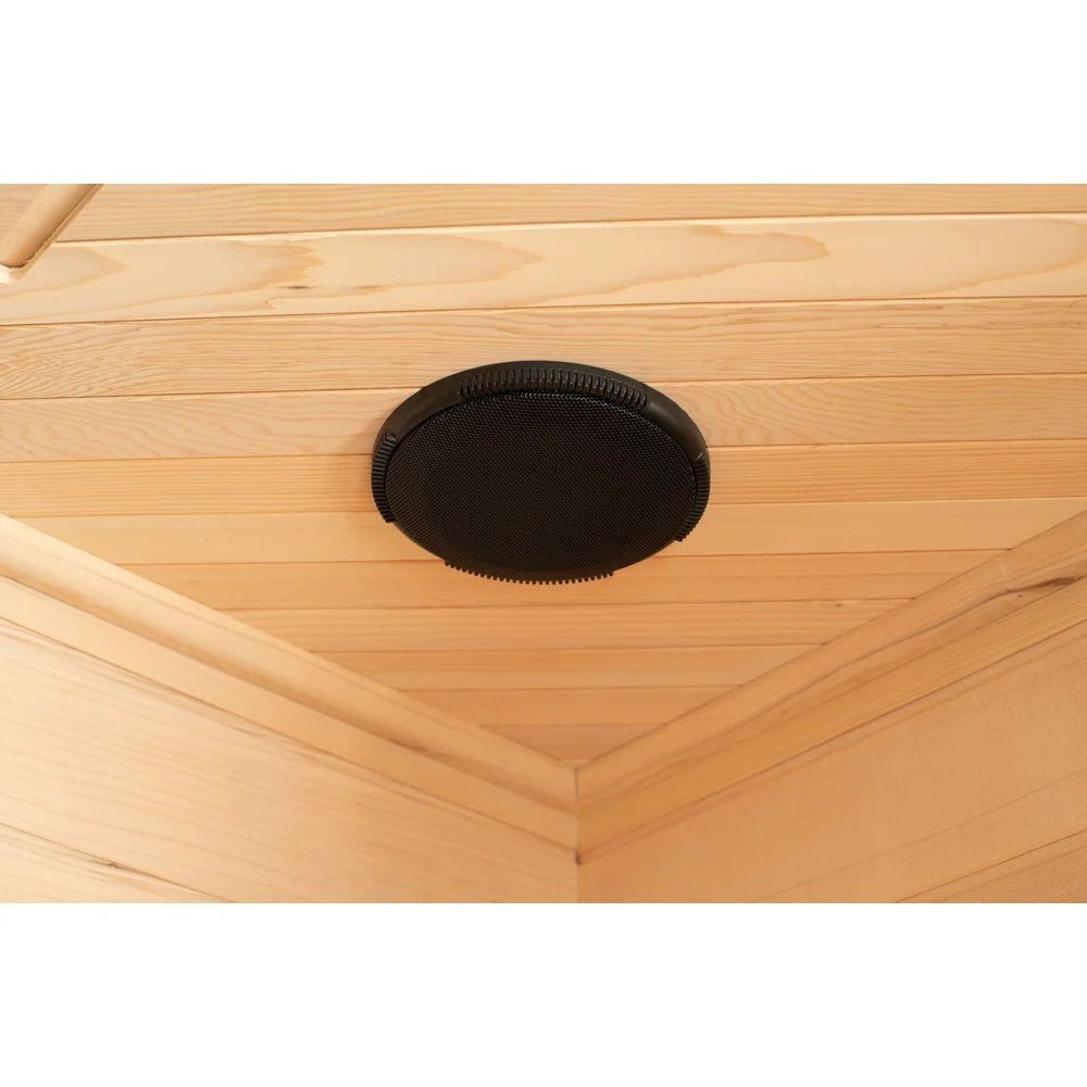 Black oval ceiling speaker recessed into the hemlock planks of the Blisspod Vienna Sauna audio system
