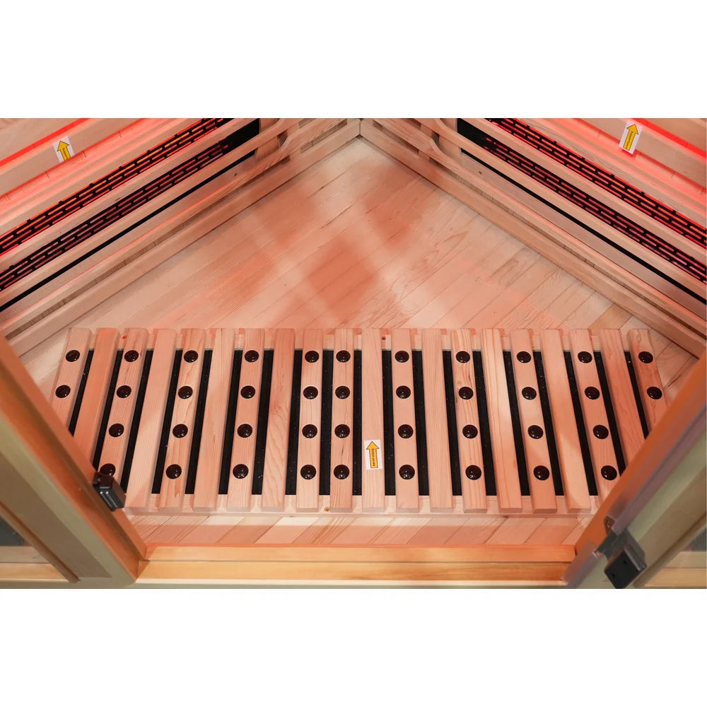 Overhead look at the ion stone footrest and glowing floor heaters of the Blisspod Vienna RED Red Light Therapy Sauna