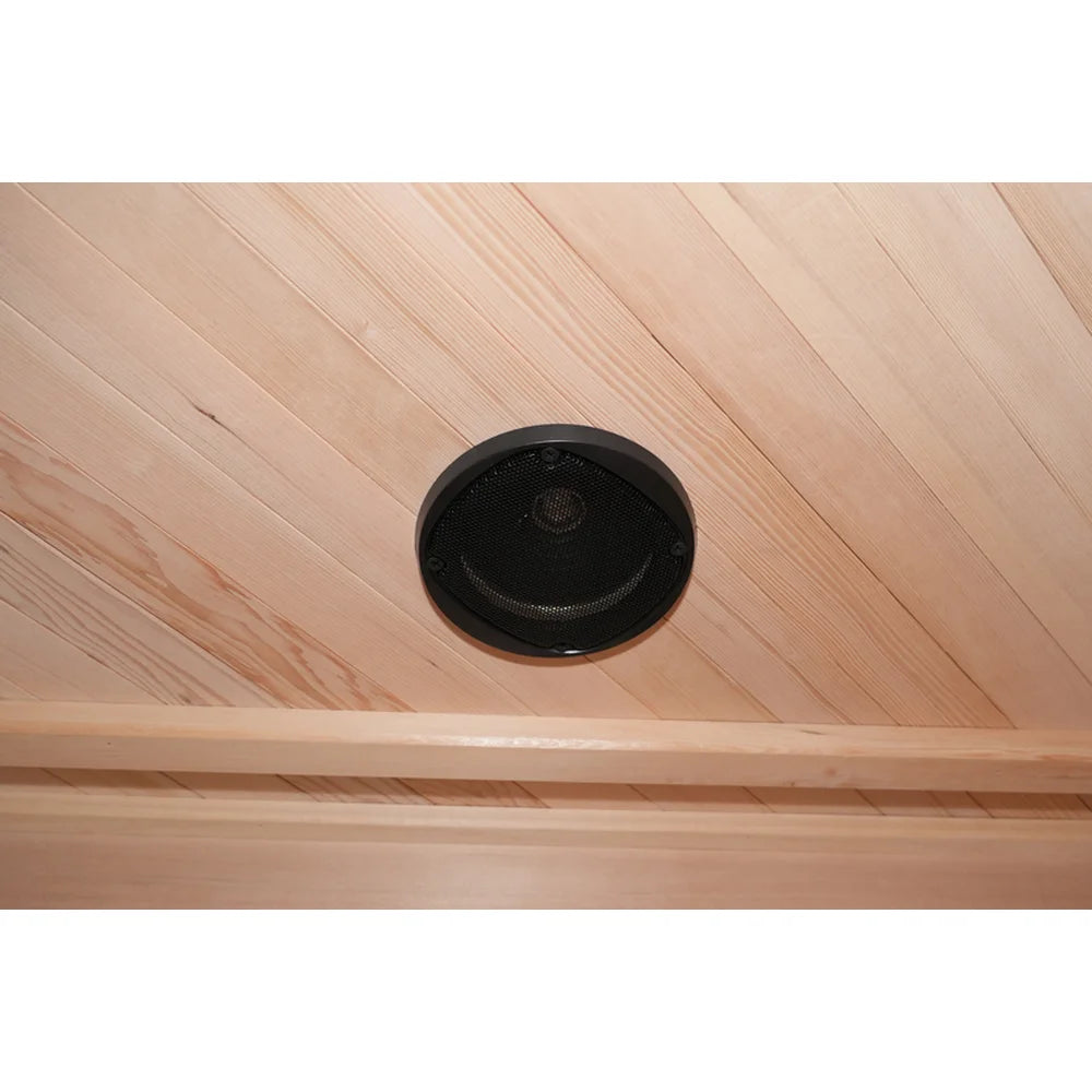 Round black ceiling speaker set into hemlock planks inside the Deluxe Sauna Vienna RED for FM and Bluetooth audio