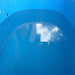 Water sitting against the blue PVC liner and drain port inside the Revive Plunge Inflatable Cold Plunge