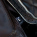 Close-up of the USB charging port tucked beside the brown quilted seat of the Infinity Palisade Pro 4D Massage Recliner