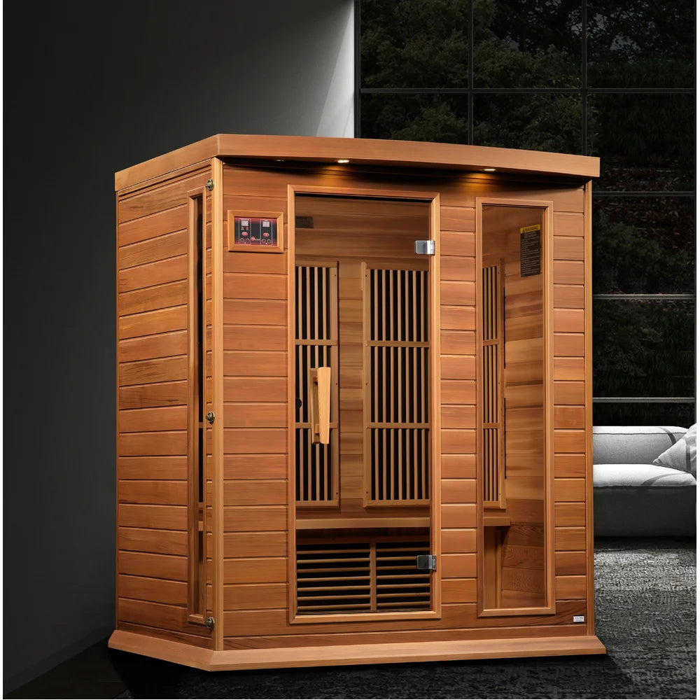 Red cedar cabin of the Maxxus Montilemar FAR IR Sauna set in a modern living room beside a window and sofa