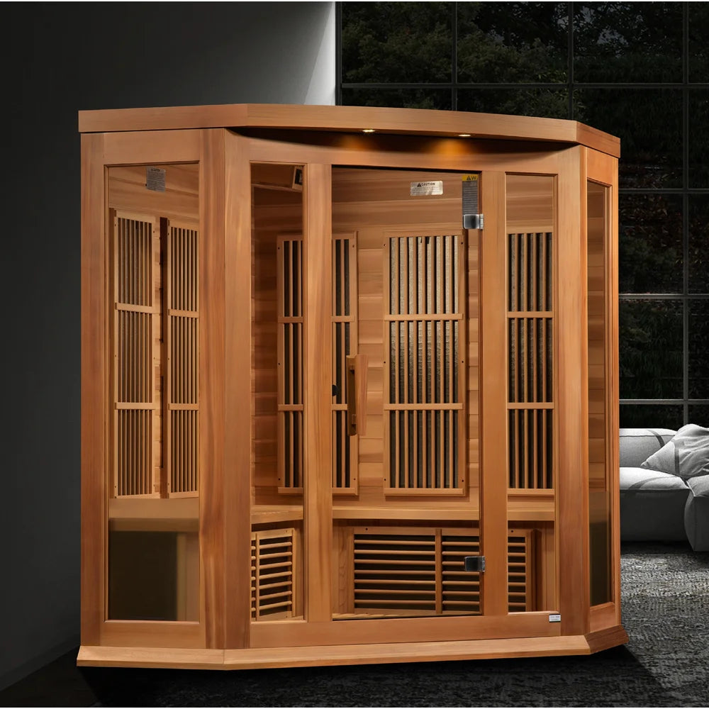 Lit cedar cabin of the Maxxus MX-K356-01-ZF Sauna staged in a dark modern room beside a window wall