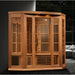 Lit cedar cabin of the Maxxus MX-K356-01-ZF Sauna staged in a dark modern room beside a window wall