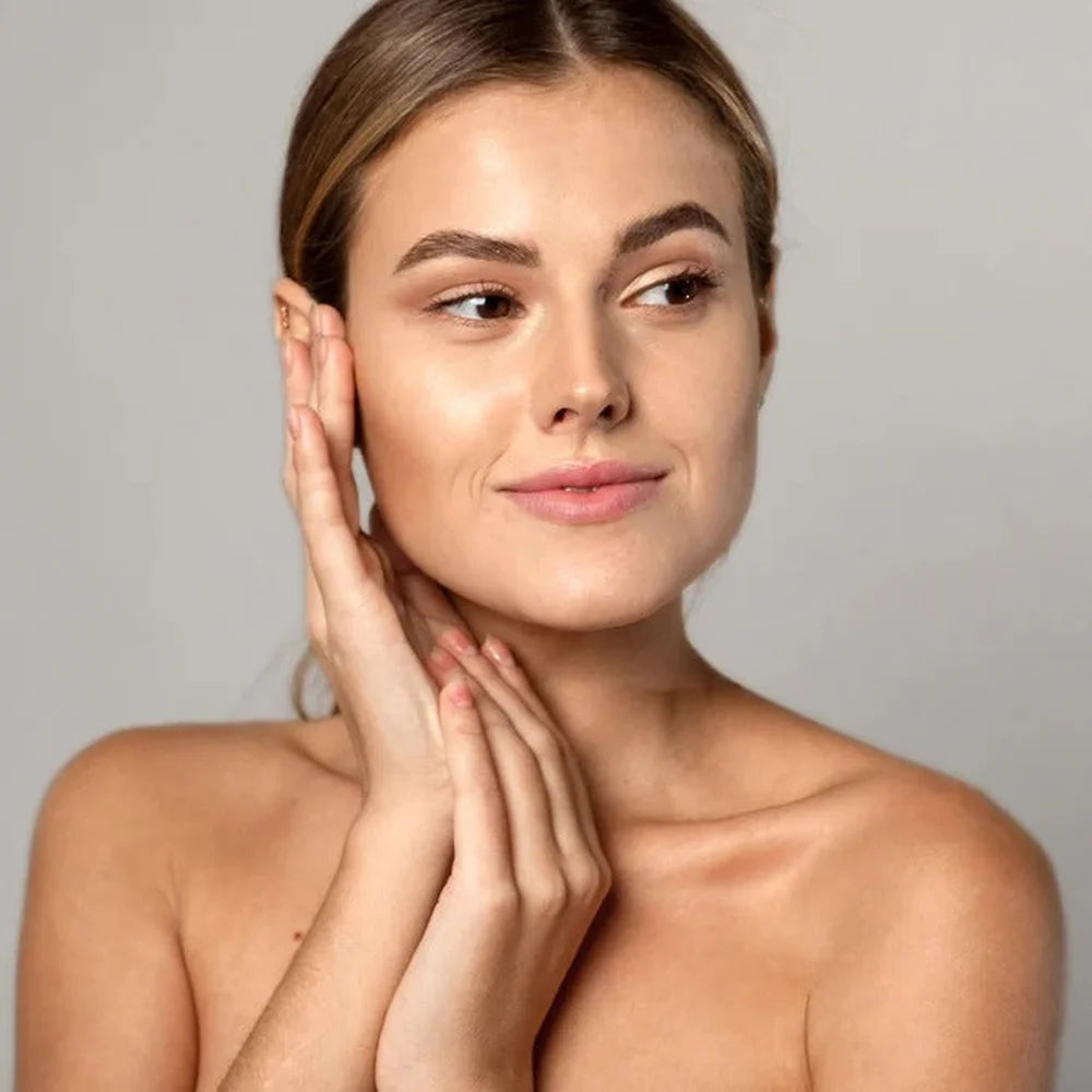 Young woman framing her face to show a clear balanced complexion, linked to the Galaxy Zero Atlas Body Wellness Device