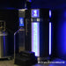 Blue-lit Cryo Innovations XR Cryotherapy Chambers unit with entry steps, side screen and nitrogen tank
