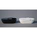 Gloss black and gloss white Dreampod Home Float Pro pods side by side on a plain studio backdrop with hatches open