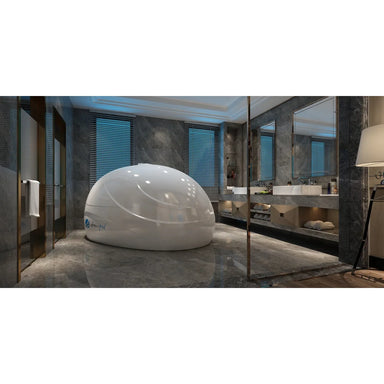 White Dreampod Sport Float Pod with closed dome lid installed in a marble spa bathroom beside twin basins