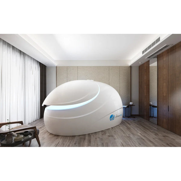 Lid raised on the Dreampod Sport Flotation Tank revealing blue LED interior lighting in a bright timber-floored room