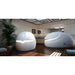Two Dreampod Sport pods in a tiled treatment room, one head-on with a lit entry seam and one in side profile