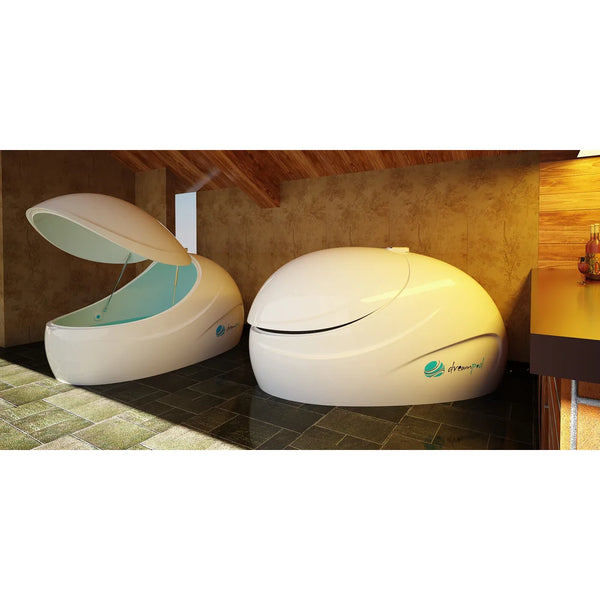 Lid raised on gas struts showing the water basin of a Dreampod Sport Float Tank beside a closed pod in a timber room