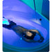 Overhead view of a woman floating with arms out in a Dreampod V2 Price model lit purple and blue inside