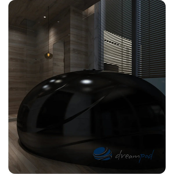 Stealth black gloss Dreampod V2 Isolation Tank with closed lid reflecting light in a dark marble interior