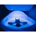 Person floating on their back inside the open pod under deep blue chakra lighting, interior of the Dreampod Vmax Float Tank