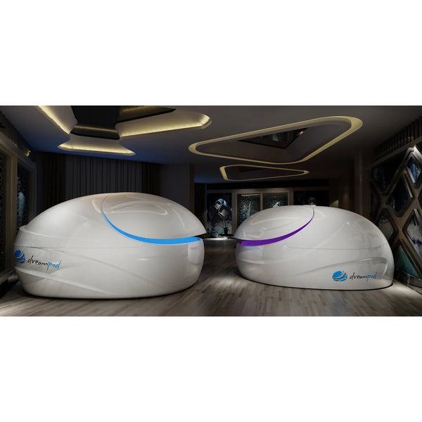 Pair of white pods with blue and purple lit door seams under sculpted ceiling lights, Dreampod Vmax Sensory Deprivation Tank duo
