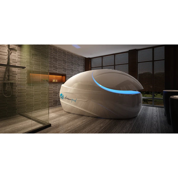 Champagne toned pod with tilted lid and blue crescent light next to a walk-in shower, the Dreampod Vmax Sensory Deprivation Tank