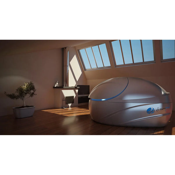 Silver grey pod with a slim blue lit seam under attic skylights, the Dreampod Vmax Float Pod in a sunlit loft space