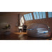 Silver grey pod with a slim blue lit seam under attic skylights, the Dreampod Vmax Float Pod in a sunlit loft space