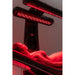 Upward view of two glowing LED lamp panels above a reclining client on the Vacu Activ Red Couch 360