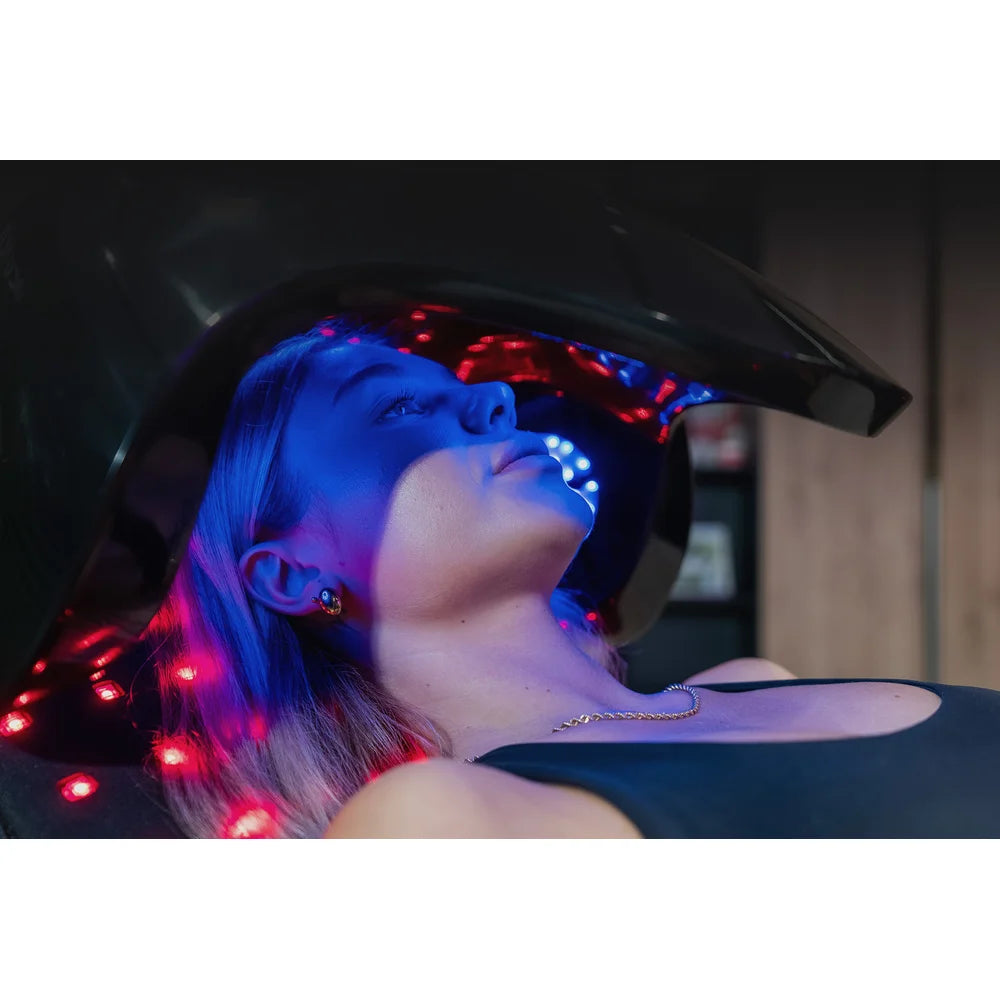 Blue and white light on skin under the hood of the Vacu Activ Red Couch Oxy during a facial LED session