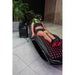 View from the foot of the Vacu Activ Red Couch Oxy Therapy Device with red diodes lit under a reclining user