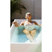 Vertical outdoor crop of a woman soaking with eyes closed in the Go Chiller Cold Plunge Fiber Core Flex Tub
