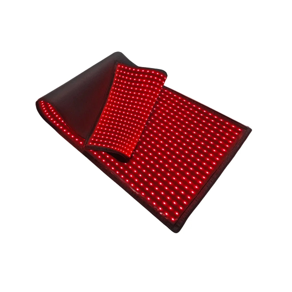 Partly folded wrap with glowing red LEDs on a white backdrop, a Kore KoreKapsule Full Body Red Light Therapy Pad view