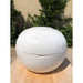 Head-on view of the Dreampod Home Float Plus showing its domed lid, panel seams and recessed handle