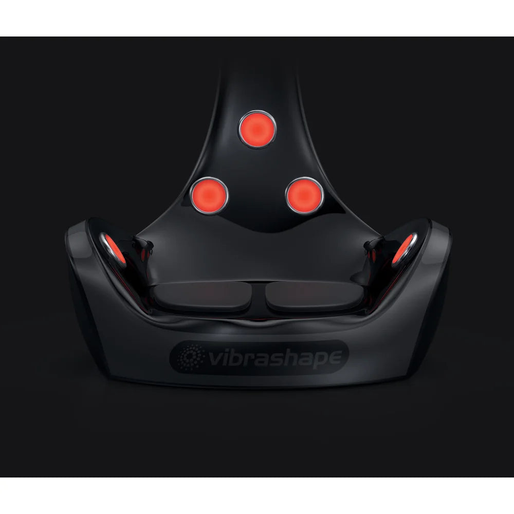 All infrared heaters glowing red on the front of the Vacu Activ Vibrashape Vibration Machine above twin footplates