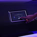 Finger selecting the acne program with timer and heat settings on the exterior touchscreen of the Spacetouch Capsule